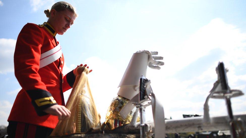 A member of the Household Cavalry , The Life Guards preparing her uniform before rehearsing for the Duke of Edinburgh's funeral