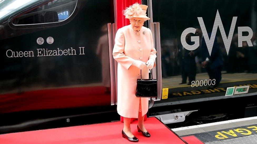 The Queen standing by train