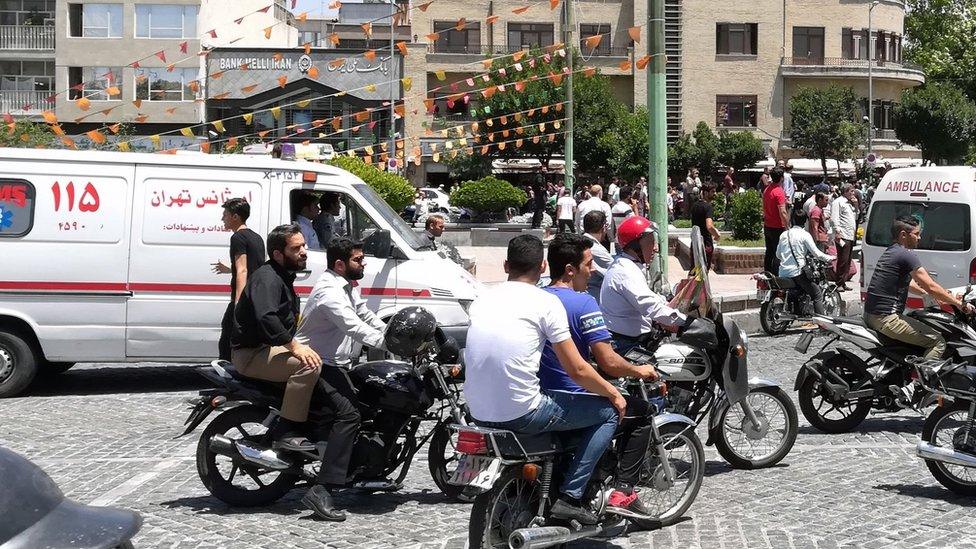 File photo showing ambulances surrounded by motorcycles in Tehran, Iran (7 June 2017)