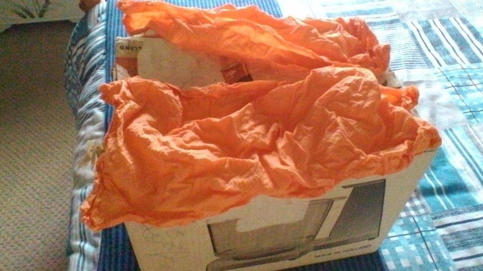 The old storage box and orange kitchen towel