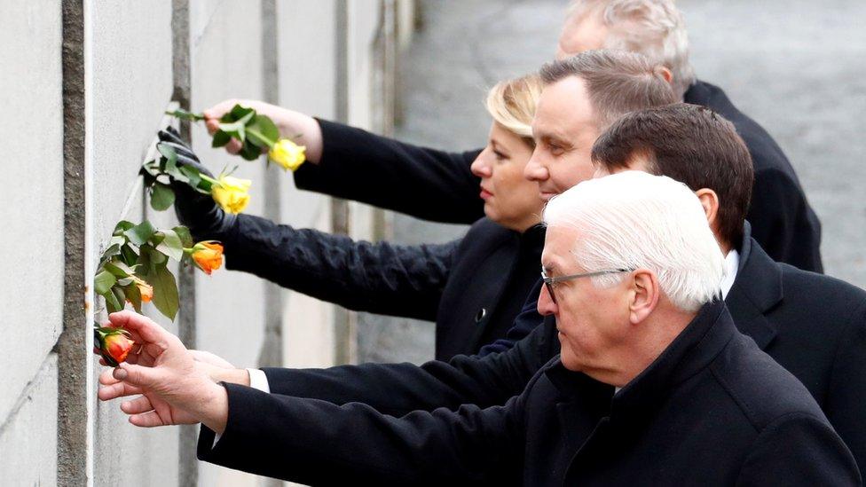 German President Frank-Walter Steinmeier, Hungary's President Janos Ader, Poland's President Andrzej Duda, Slovakia's President Zuzana Caputova and Czech Republic's President Milos Zeman place roses into a gap at the Wall memorial