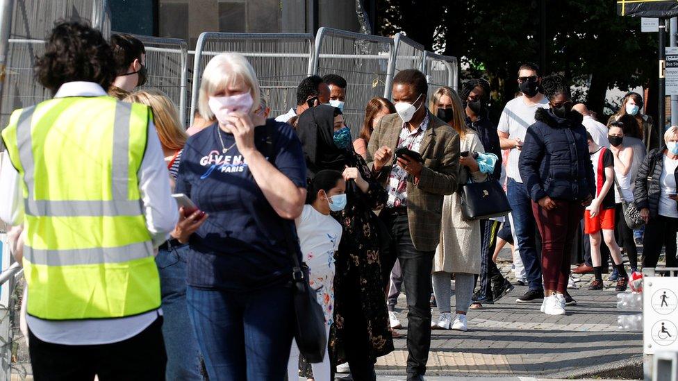 People queuing to get vaccinated in Bolton