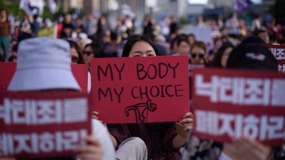 Protesters hold placards reading 'Abolish punishment for abortion' as they protest South Korean abortion laws in Gwanghwamun plaza in Seoul on July 7, 2018