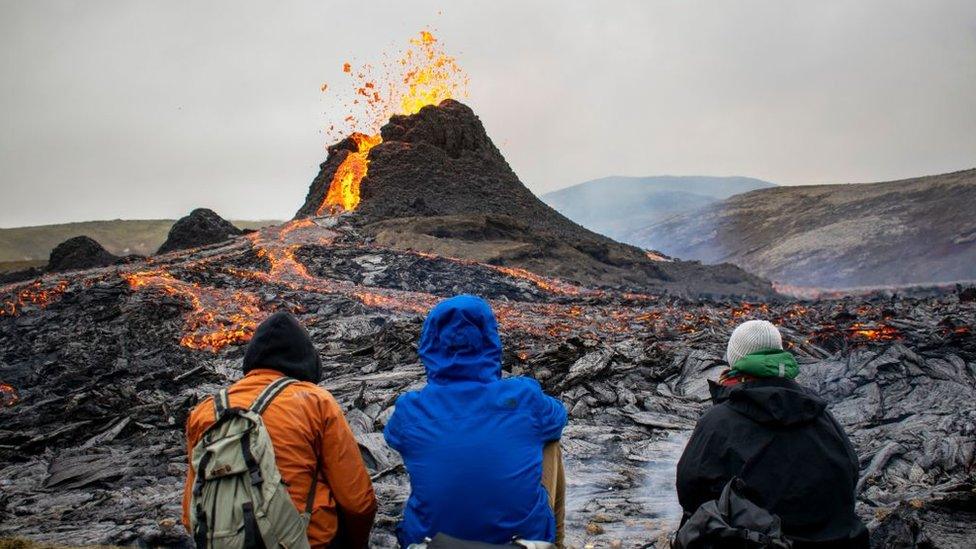 hikers-watching-volcano-at-the Fagradalsfjall-area-in-Iceland.