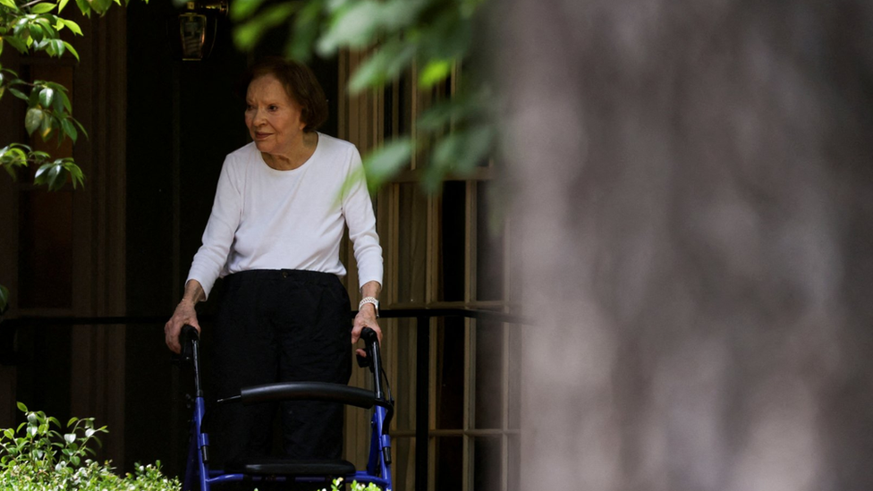 Former first lady Rosalynn Carter walking with a walking frame