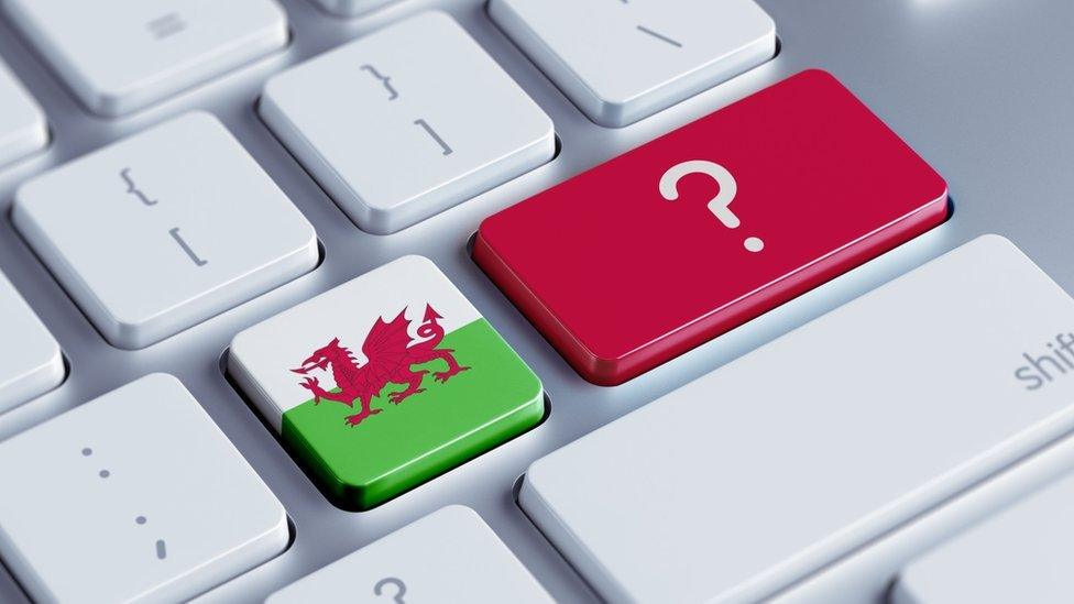 A Welsh flag on a keyboard with a question mark