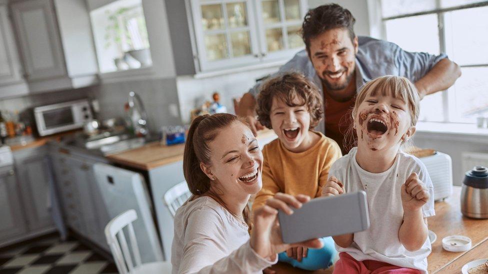 family eating chocolate and taking a selfie