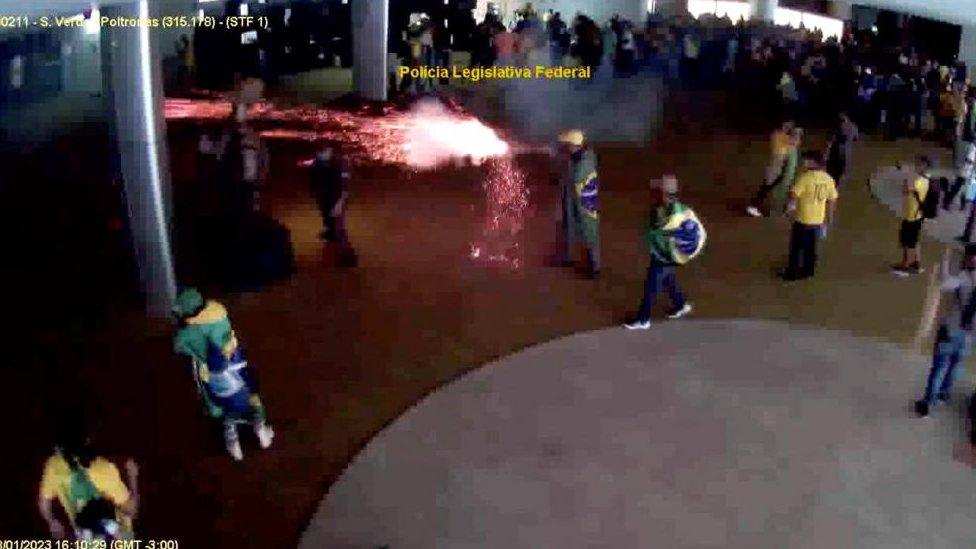 Surveillance camera footage shows a man using a rocket as a weapon, at the Congress, in Brasilia, Brazil, January 8, 2023, in this screen grab taken from a handout video.