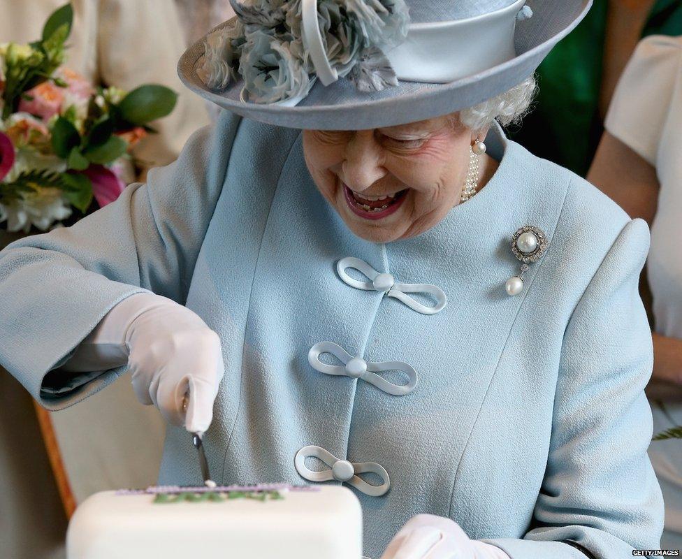 The Queen cutting a cake