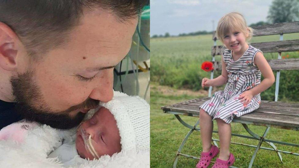 Carl Birks kisses his baby daughter Felicity and a photo of Felicity, now four