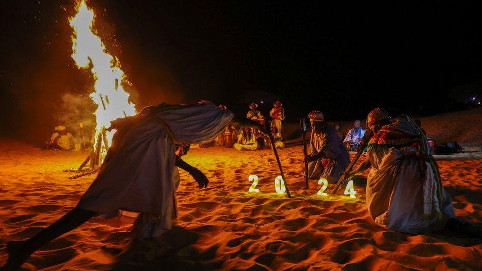 Senegalese music group Ngueweul Rythme and French music group Tambour Fanfare sing folk music and perform traditional dance around fire as part of the new year celebration in Lompoul desert