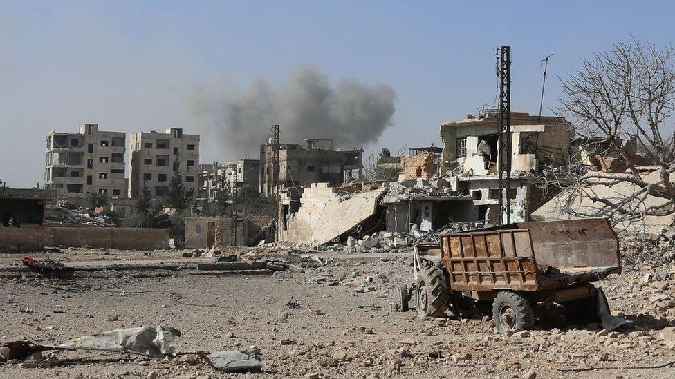 Smoke rises from the town of Hamouria in the besieged, rebel-held Eastern Ghouta area, as seen from Beit Sawa, recently captured by government forces (14 March 2018)