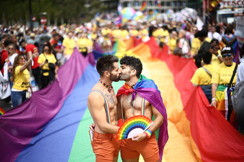 A couple kiss, while taking part in the 2022 Pride Parade in London, on 2 July 2022.