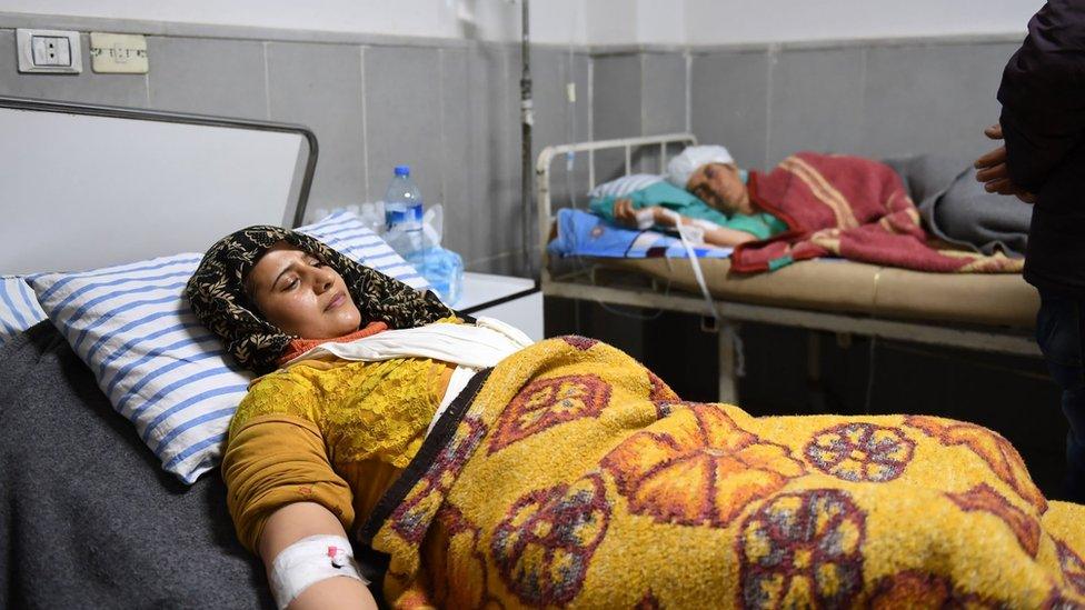 Syrians who were injured during an offensive by Turkish-led forces on the Kurdish enclave of Afrin receive treatment at a hospital (25 January 2018)