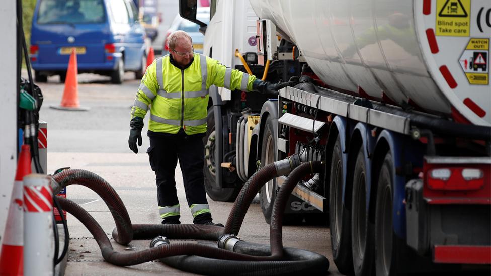 A delivery driver refills the pumps at a petrol station in Flamstead, St Albans, 29 September 2021