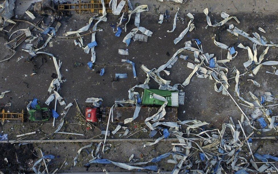 An aerial picture shows damaged trucks and a shipping container near the site of explosions, in Tianjin, China, on 15 August, 2015