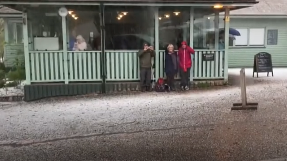 People sheltering in Bodnant Gardens during a hailstorm earlier this month