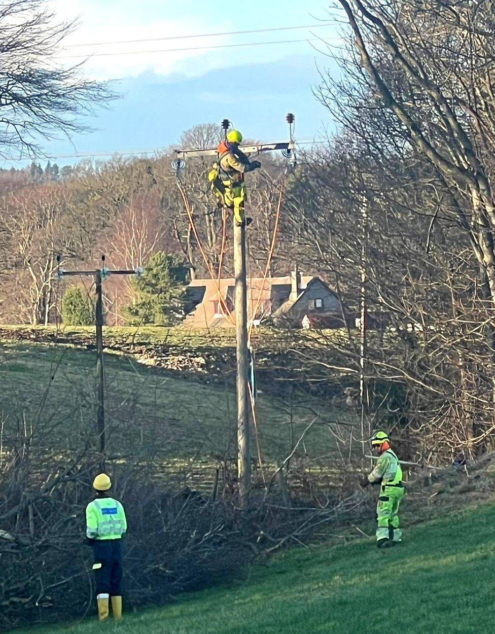 Engineers fixing power lines