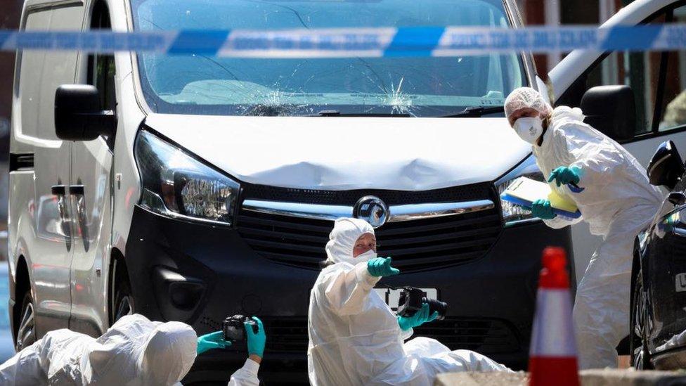 Forensic officers work on a van in Bentinck Road