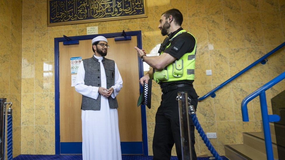 Imam Qari Asim talks to PC Plumber as he visits the Makkah Mosque in Leeds