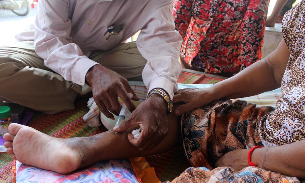 Man giving woman injection