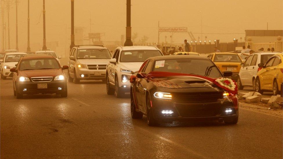 Traffic on road in sandstorm.