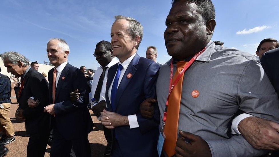 Prime Minister Malcolm Turnbull links arms with fellow lawmakers during the event