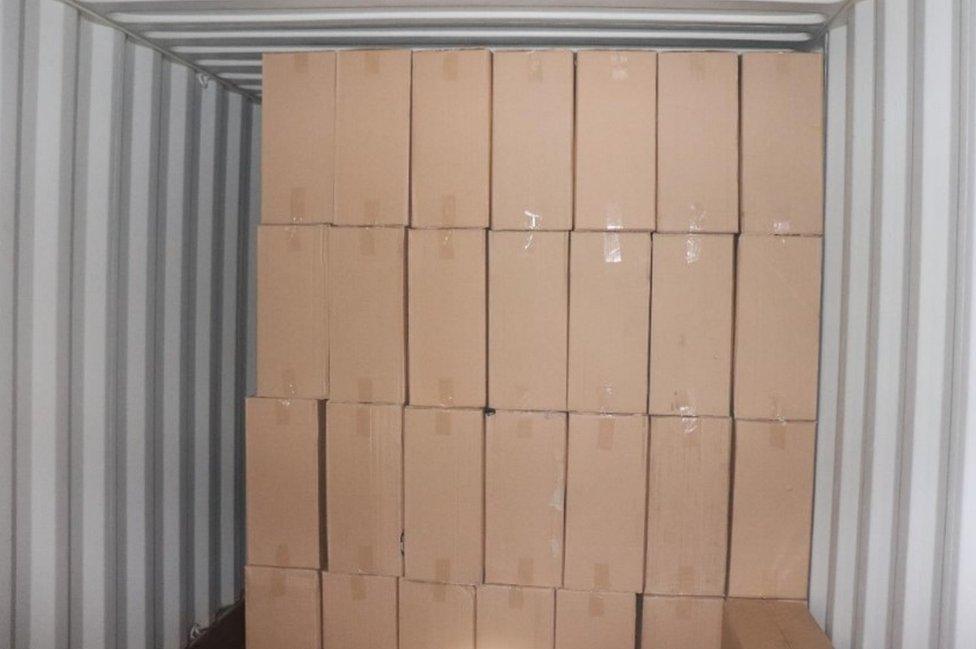 Dozens of brown cardboard boxes in a container