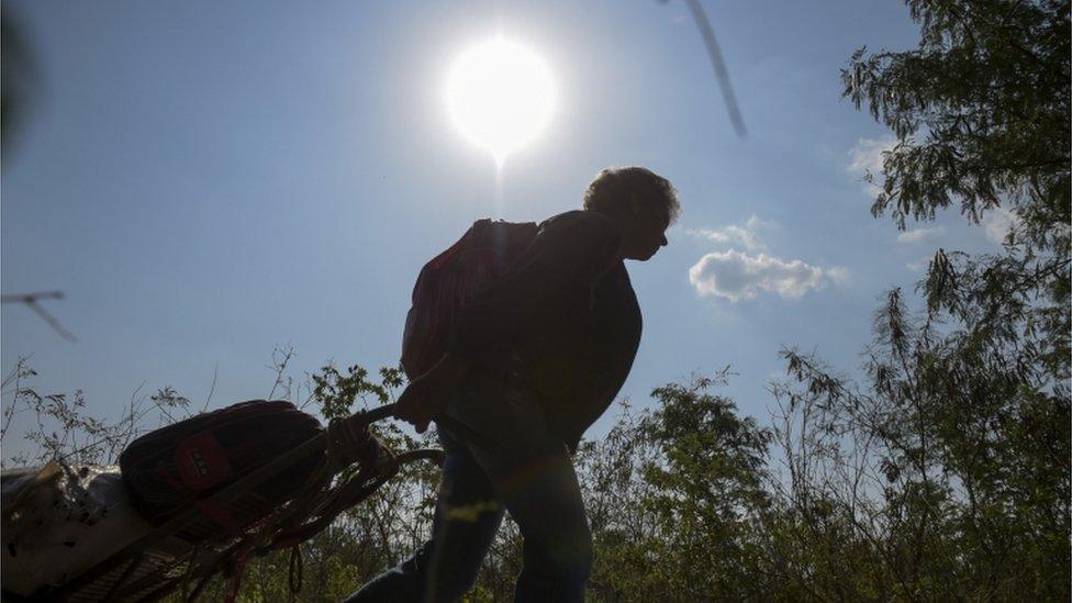 Colombian Maria who lives in Venezuela, pulls a cart with scrap metal to sell