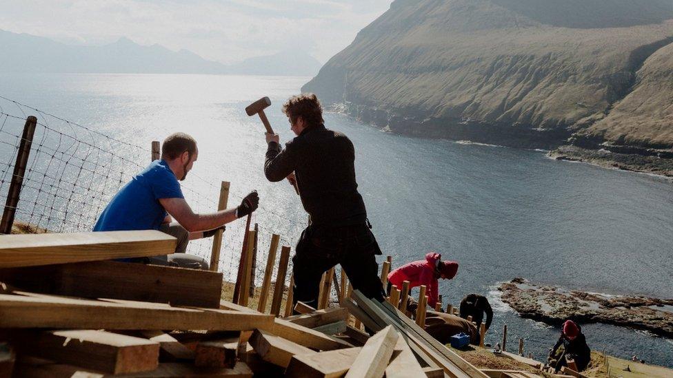 Pink Group members build steps in Gjógv