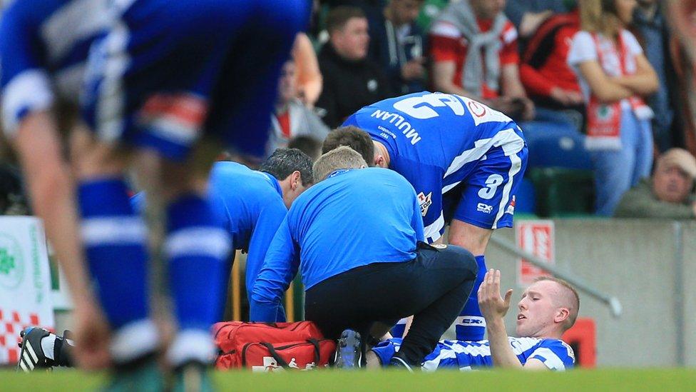 Coleraine's Stephen Dooley was carried off after sustaining an ankle injury during the first half