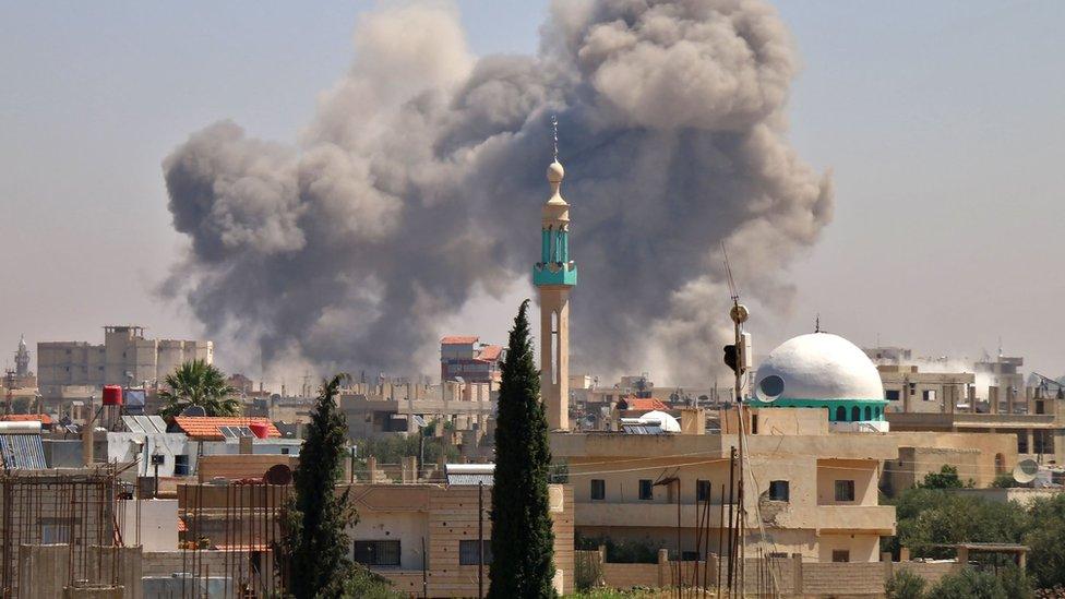 Smoke rises from the rebel-held town of Nawa, north of Deraa, Syria, during air strikes by pro-government forces (27 June 2018)