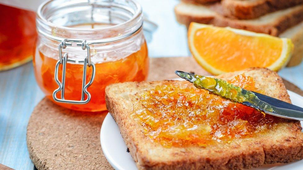 Orange marmalade on a slice of toast