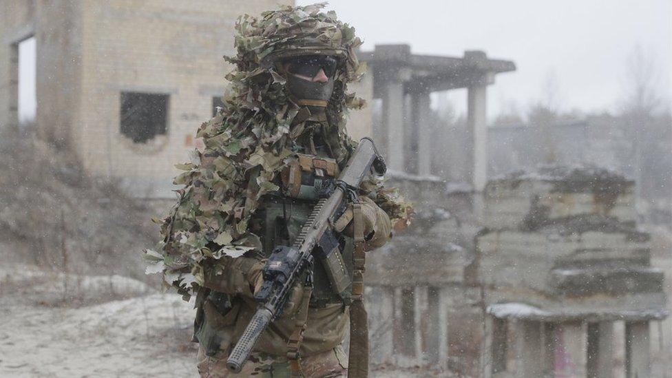 A Ukrainian soldier wearing camouflage while taking part in drills