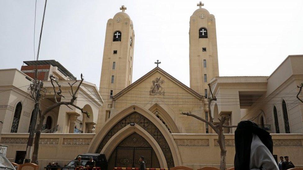 A woman passes in front of the Coptic church that was bombed on Sunday (10 April 2017)