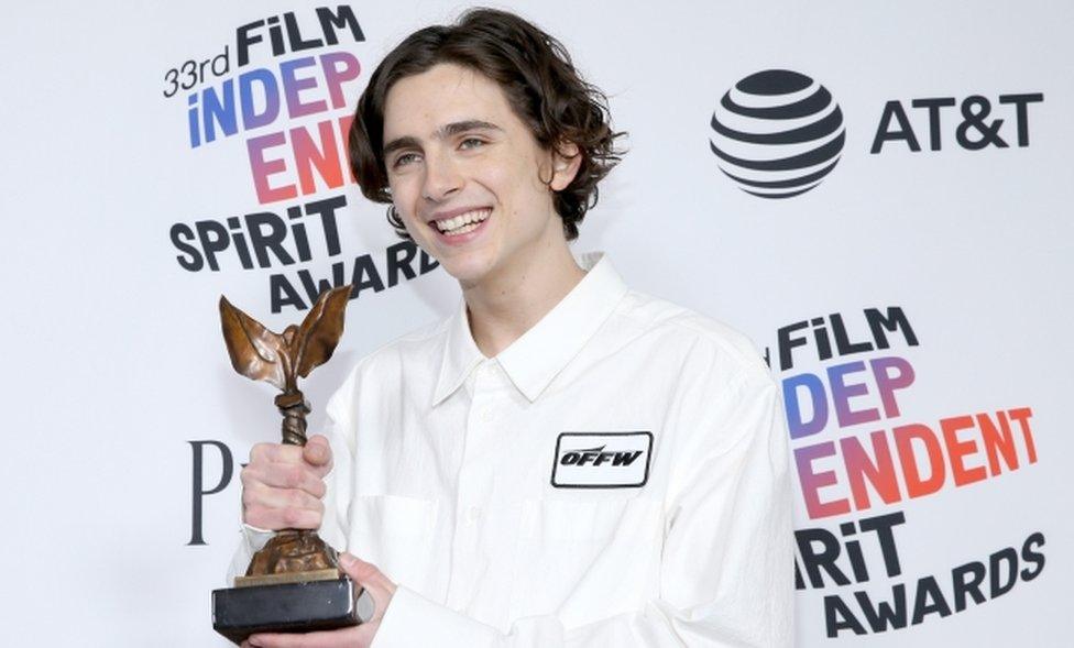 Timothee Chalamet beams with his award