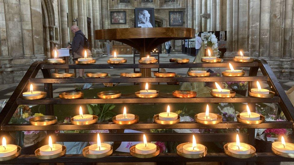 Candles lit in front of a photo of the Queen at Beverley Minster