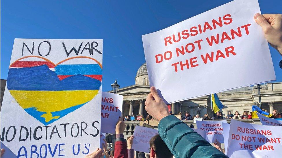 People holding signs "RUSSIANS DO NOT WANT THE WAR" take part in a demonstration in Trafalgar Square, London, to denounce the Russian invasion of Ukraine.