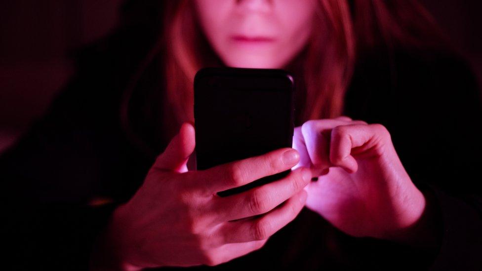 Stock photograph of a woman using a phone