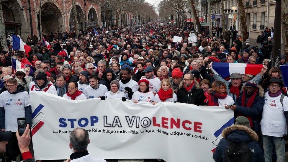 Red scarves - opponents of the yellow vests - take part in a rally in Paris, January 27, 2019