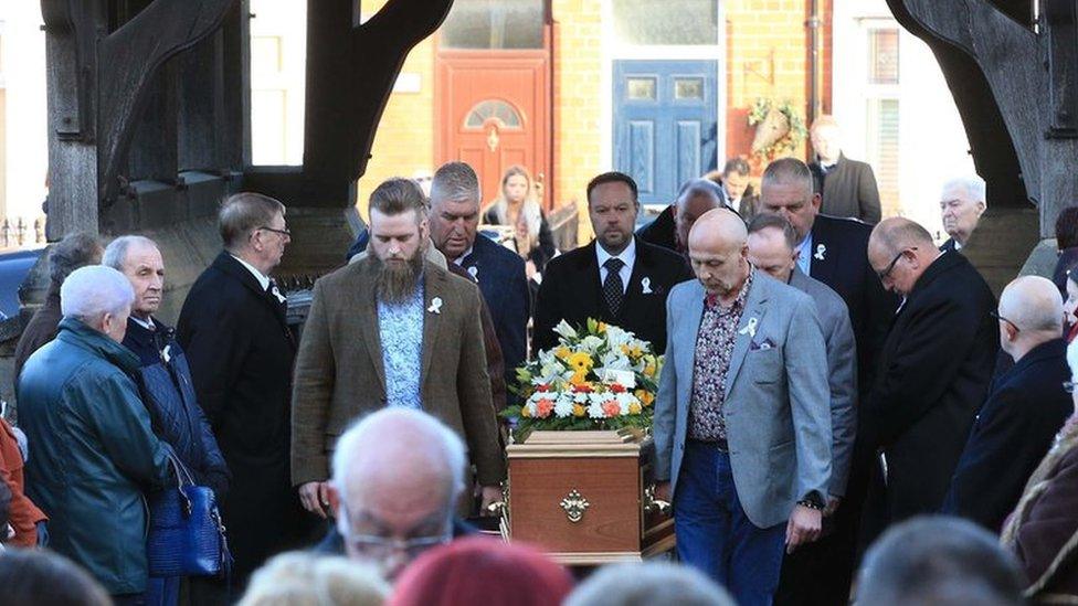 Carl Sargeant's coffin is brought to the funeral service