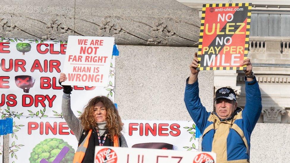 Protestors holding signs at Ulez demonstration