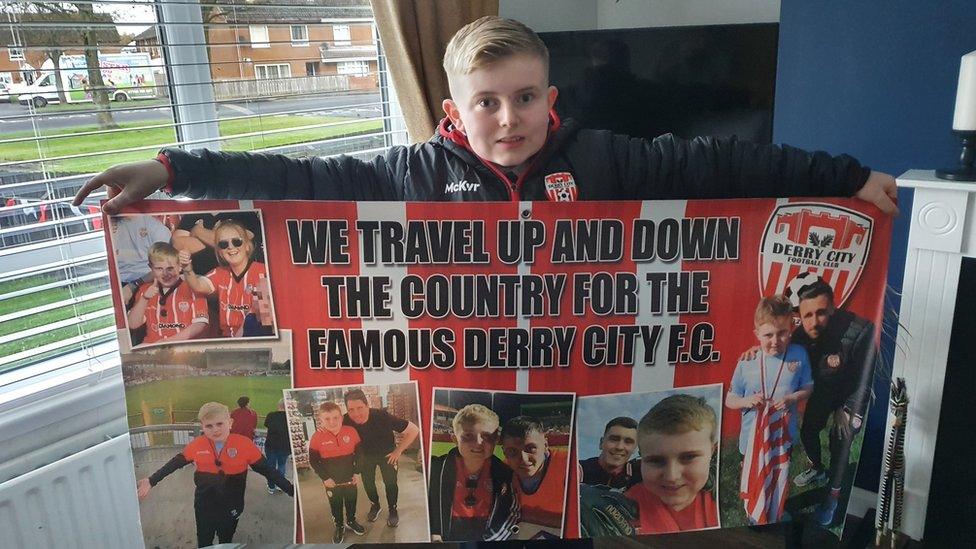 ronan mcdaid holding his derry city banner