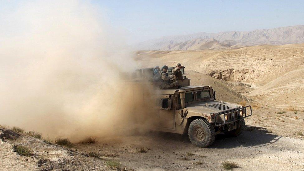 An Afghan security vehicle advances towards the city of Kunduz