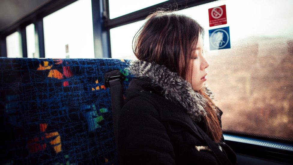 A girl sleeping on the bus