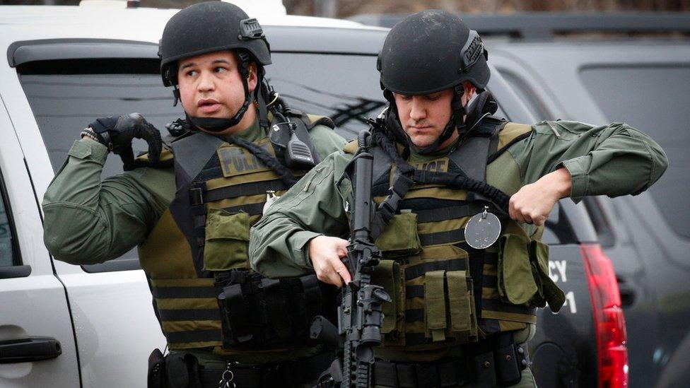 Police officers arrive at the scene of an active shooting in Jersey City