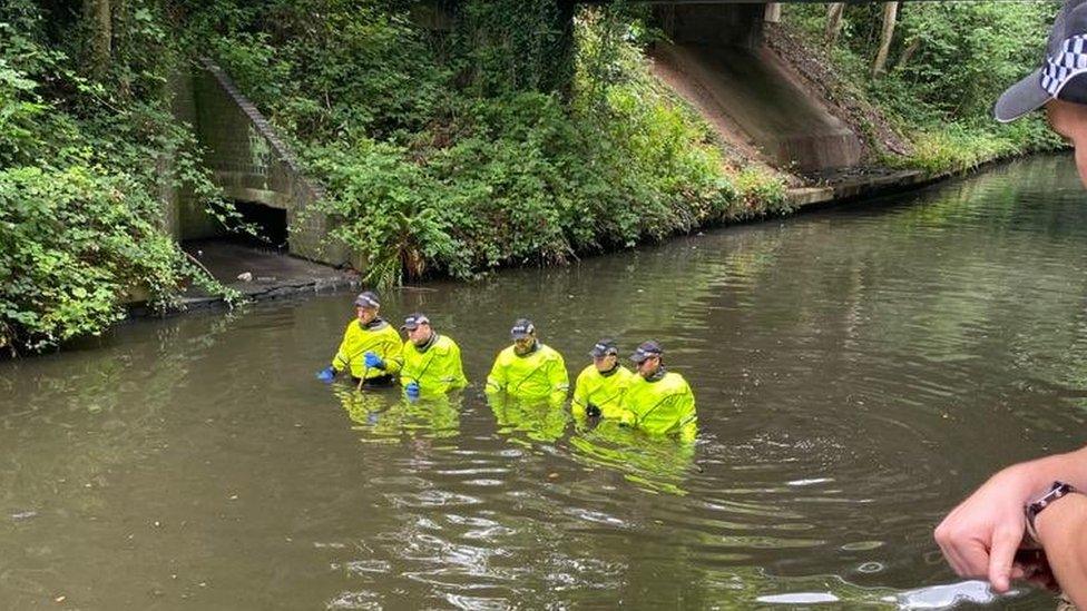 Police officers in canal