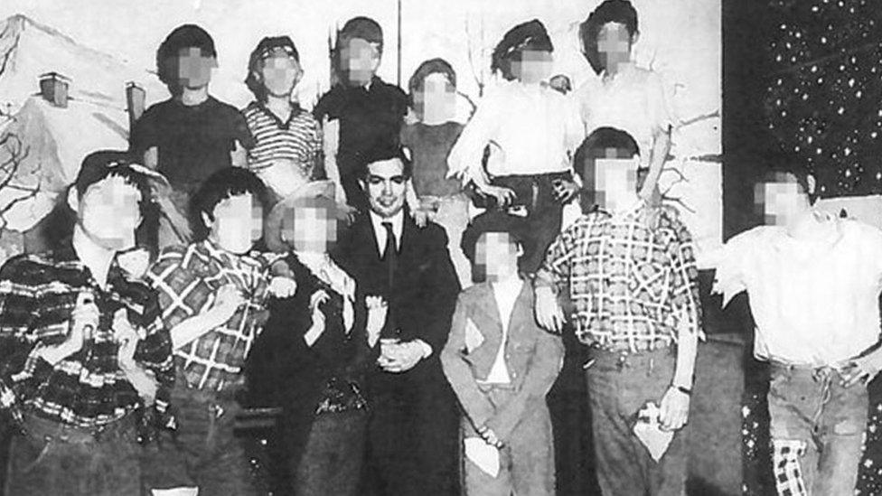 John Allen in an old photo surrounded by unidentifiable children