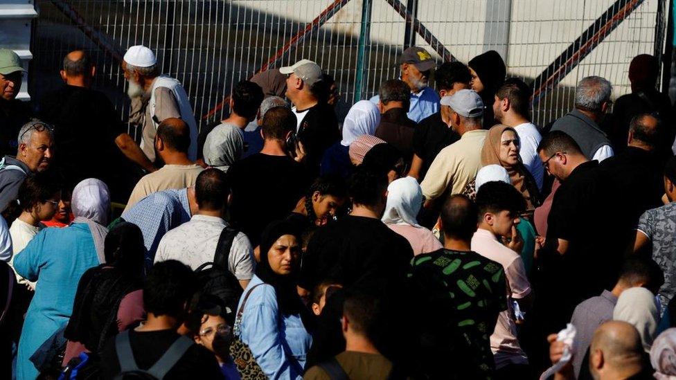 Palestinians with dual citizenship gather outside Rafah border crossing with Egypt - 16 October 2023