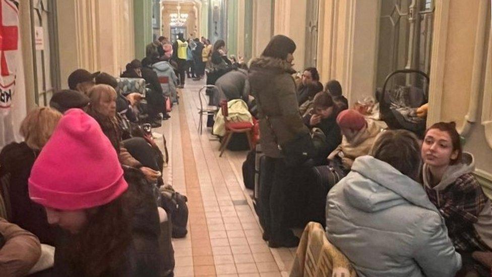 refugees gather in a building Przemysl, Poland